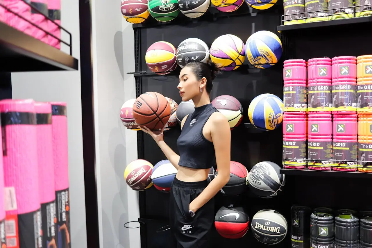 a women holding a basket ball