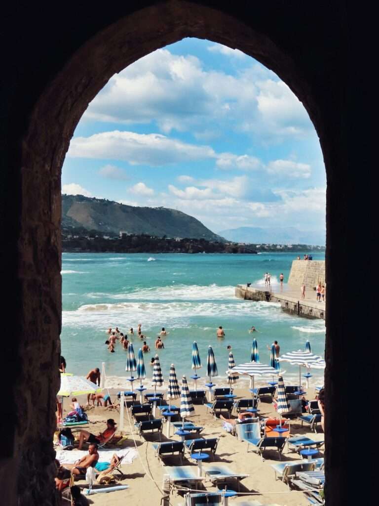 People on Beach in Cefalu in Italy By Tugce Turan