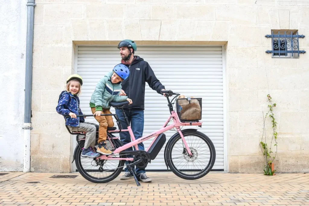 Family Riding Pink Cargo Bike in Paris