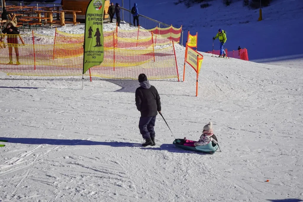 Family Fun at a Ski Resort in Winter (Italy)